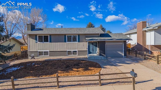 view of front of home with a garage and central air condition unit