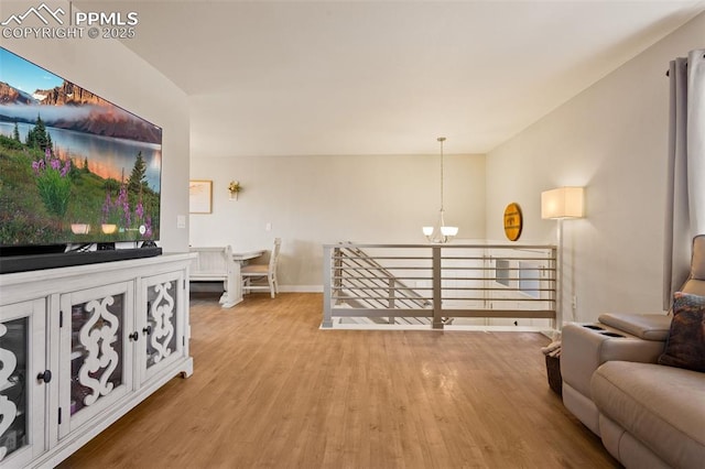 living room with an inviting chandelier and hardwood / wood-style floors