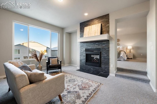 carpeted living room featuring a fireplace