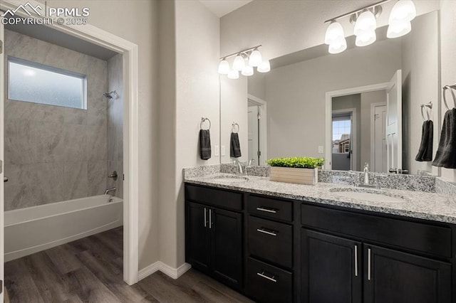 bathroom featuring tiled shower / bath, wood-type flooring, and vanity