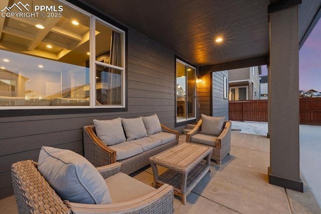 patio terrace at dusk featuring an outdoor hangout area