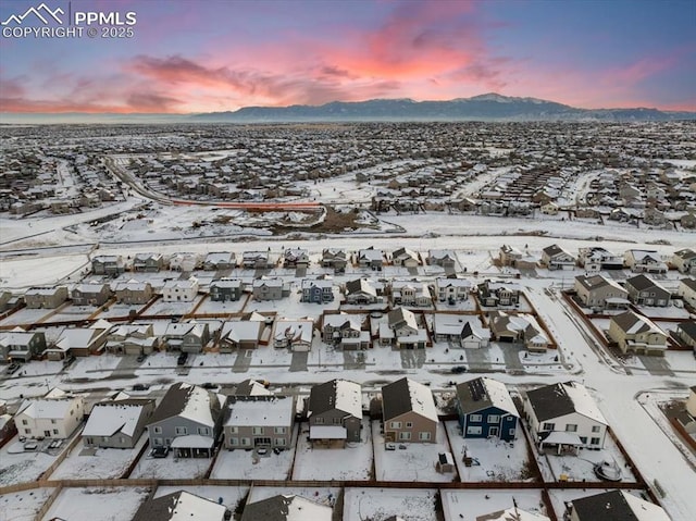 snowy aerial view featuring a mountain view