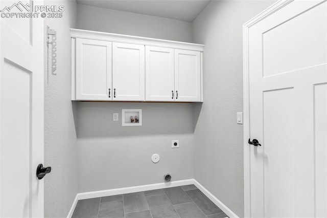 laundry room featuring cabinets, hookup for a washing machine, electric dryer hookup, dark tile patterned flooring, and hookup for a gas dryer