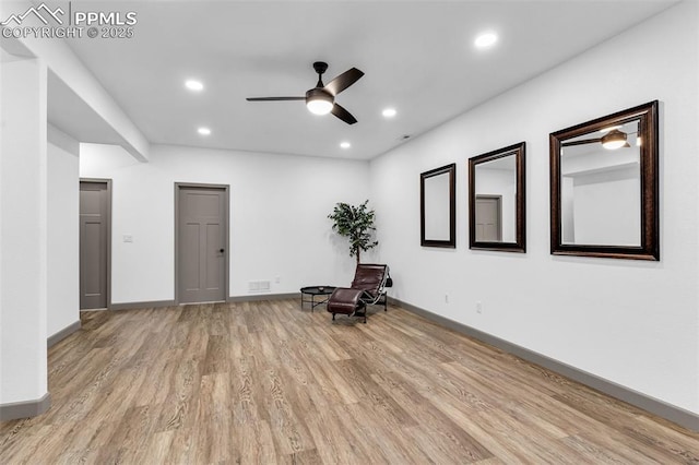 unfurnished room with ceiling fan and light hardwood / wood-style floors