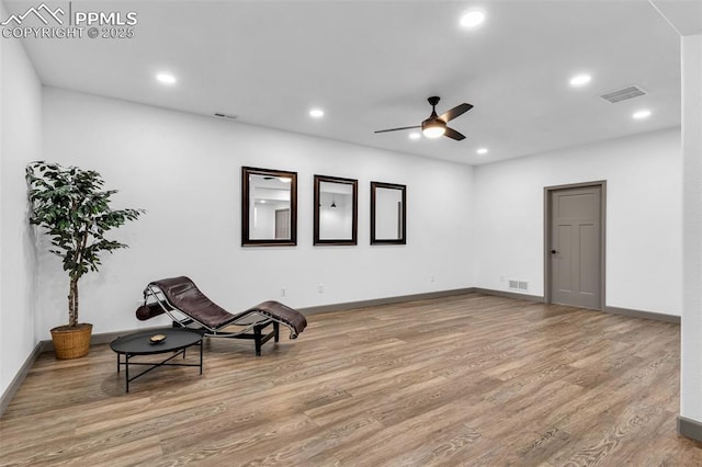 sitting room featuring light wood-type flooring and ceiling fan