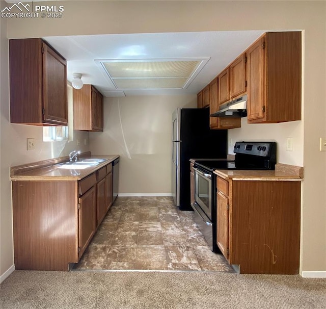 kitchen with stainless steel appliances, light colored carpet, and sink