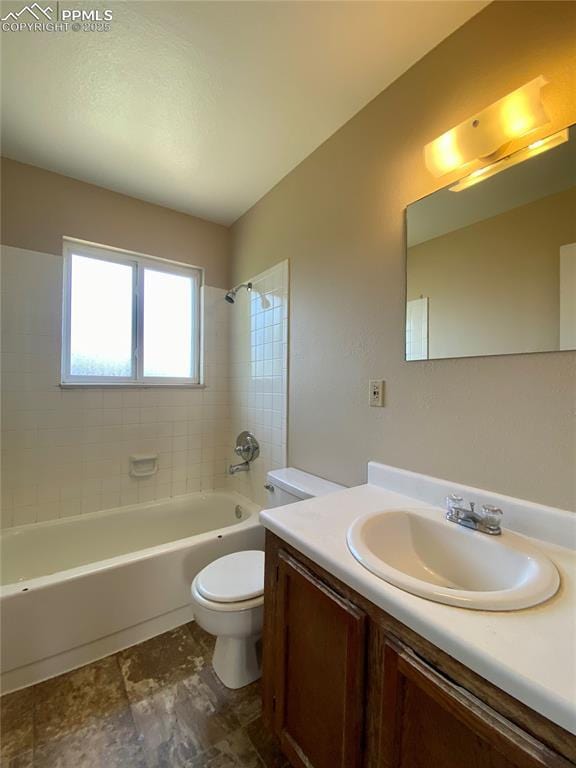 full bathroom featuring vanity, toilet, and tiled shower / bath