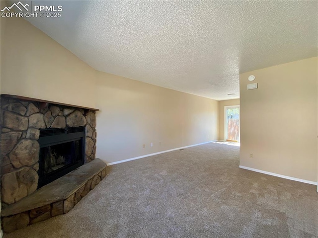 unfurnished living room with carpet flooring, a fireplace, and a textured ceiling