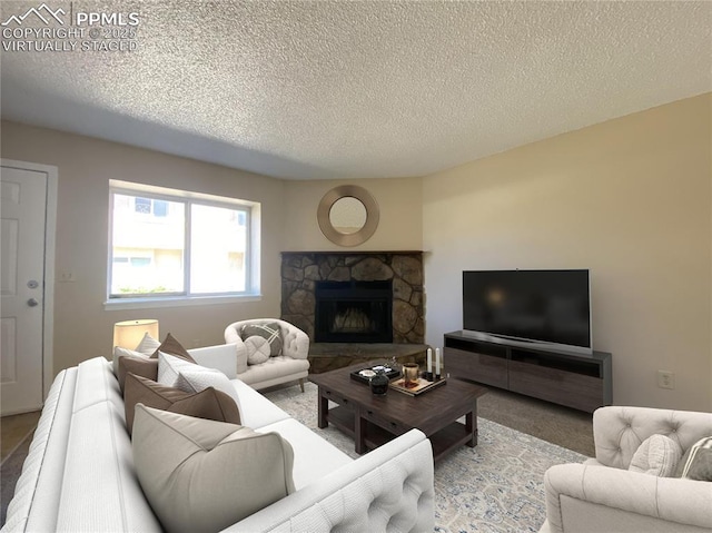 living room featuring a fireplace and a textured ceiling