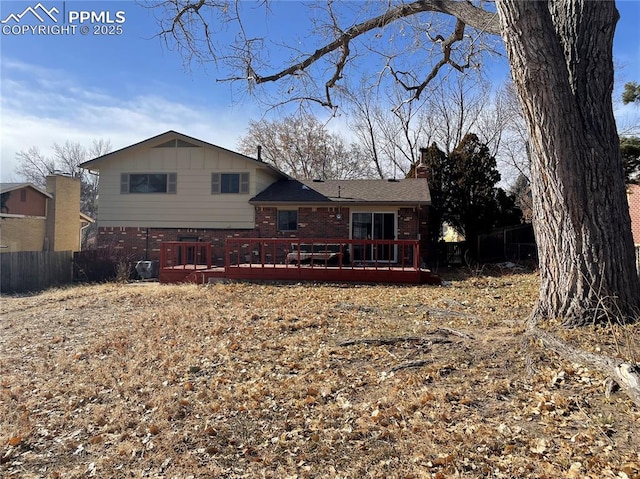 rear view of property with a wooden deck