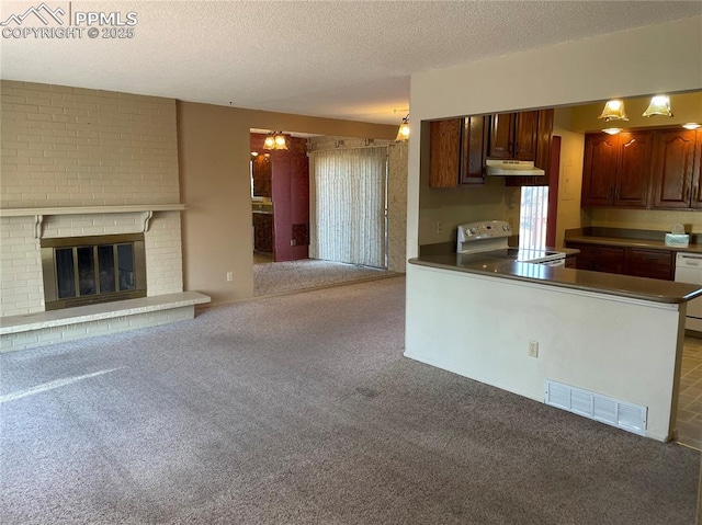 kitchen with light carpet, a brick fireplace, white appliances, a textured ceiling, and dark brown cabinetry