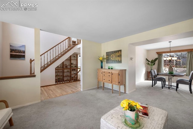 living room with light carpet and an inviting chandelier