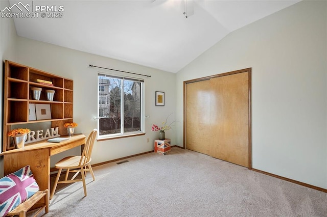 carpeted office with ceiling fan and vaulted ceiling