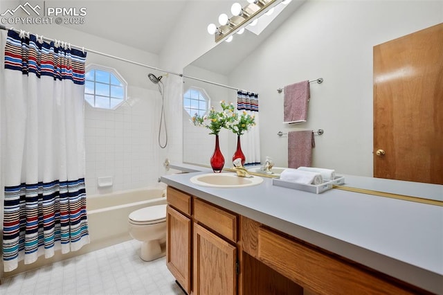 full bathroom with vanity, lofted ceiling with skylight, shower / tub combo, and toilet