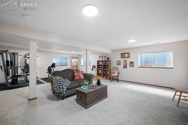 carpeted living room featuring a textured ceiling