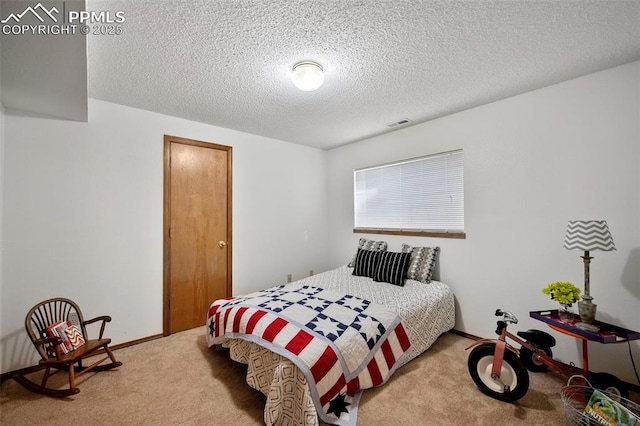 carpeted bedroom with a textured ceiling