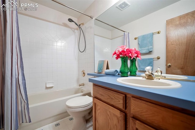 full bathroom with vanity, shower / bath combo with shower curtain, and toilet