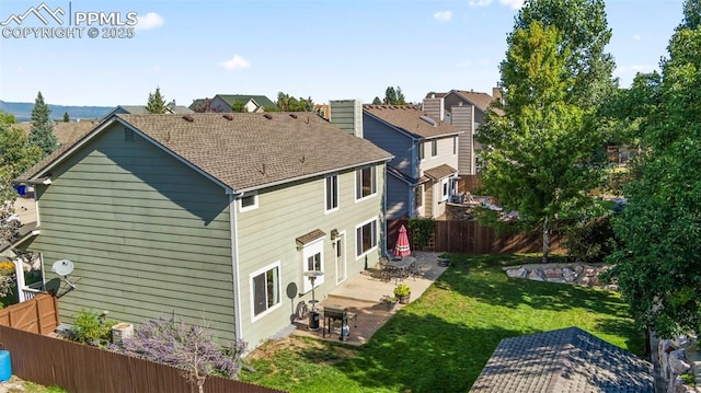 back of property featuring a lawn and a patio