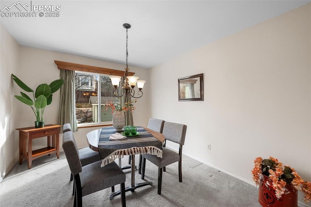 carpeted dining space featuring a notable chandelier