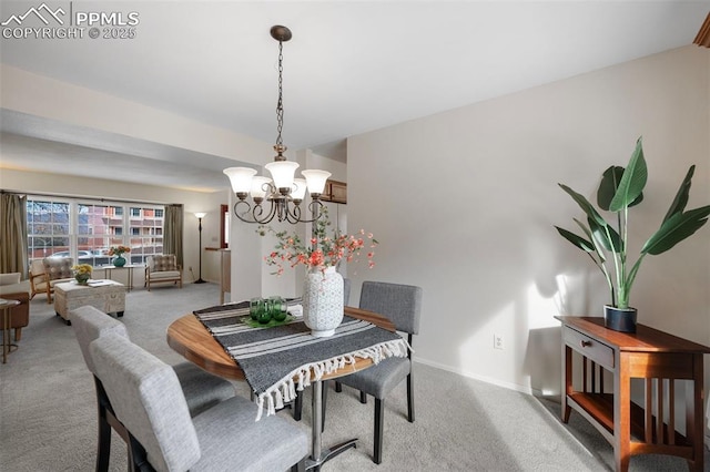 carpeted dining space with a chandelier