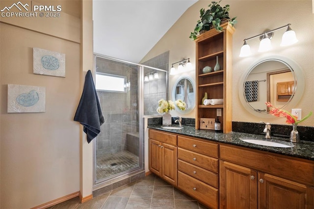 bathroom with vanity, tile patterned flooring, vaulted ceiling, and a shower with door