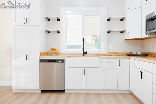 kitchen featuring white cabinets, sink, and appliances with stainless steel finishes