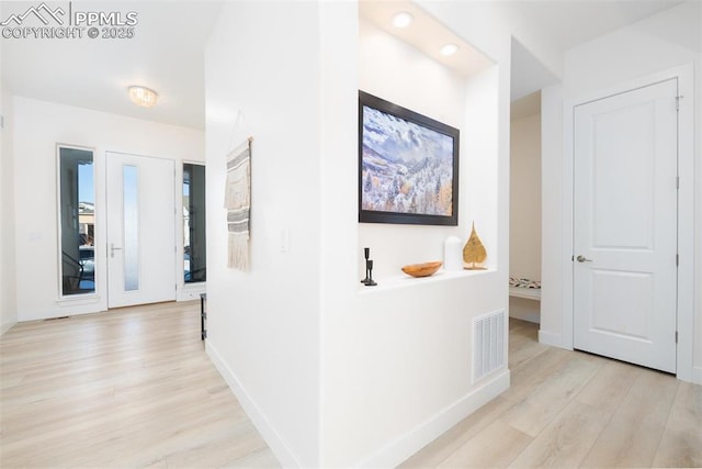 hall with light hardwood / wood-style floors