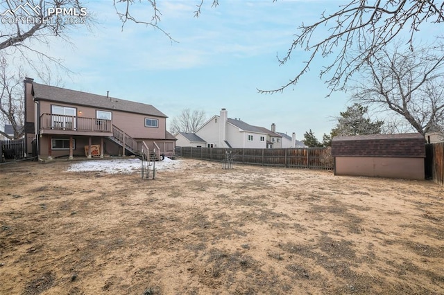 view of yard with a wooden deck and a storage unit