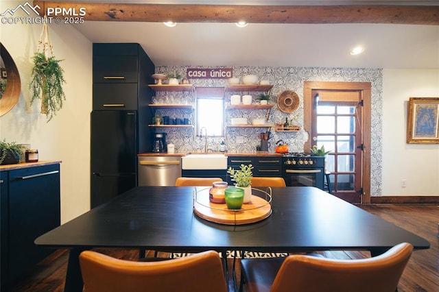 kitchen featuring dark hardwood / wood-style flooring, sink, beamed ceiling, and appliances with stainless steel finishes