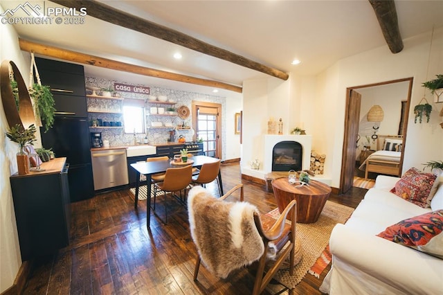 living room with beamed ceiling, dark hardwood / wood-style flooring, and sink