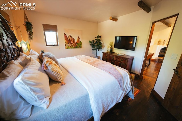 bedroom with dark hardwood / wood-style floors