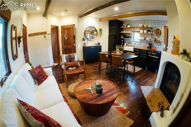 living room with beam ceiling and dark hardwood / wood-style flooring