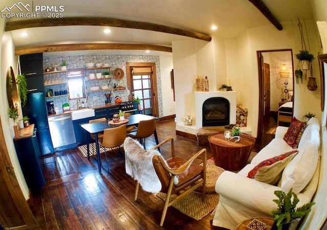 living room with beamed ceiling, dark hardwood / wood-style floors, and sink