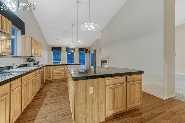 kitchen featuring light brown cabinetry, light hardwood / wood-style floors, dishwasher, and a center island