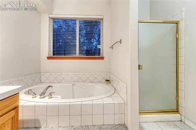 bathroom featuring vanity and shower with separate bathtub