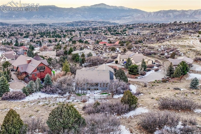 aerial view at dusk featuring a mountain view