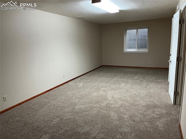 carpeted spare room featuring a textured ceiling