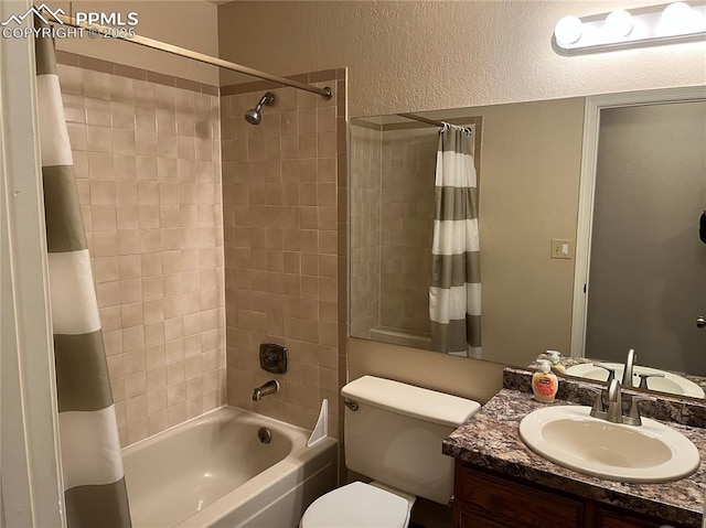 full bathroom featuring shower / bath combo, vanity, and toilet