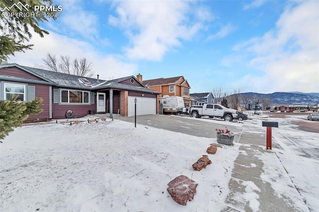 view of front of home with a mountain view and a garage