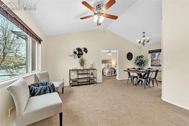 sitting room featuring ceiling fan with notable chandelier, carpet, and lofted ceiling