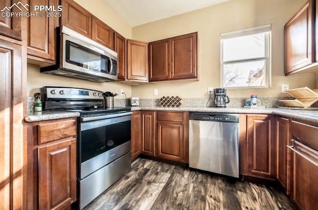 kitchen featuring dark hardwood / wood-style flooring and stainless steel appliances