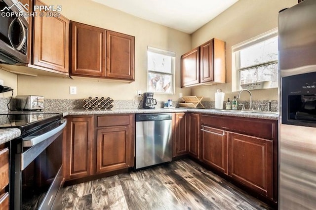 kitchen featuring sink, stainless steel appliances, and dark hardwood / wood-style floors