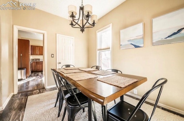 dining area featuring a notable chandelier and dark hardwood / wood-style flooring