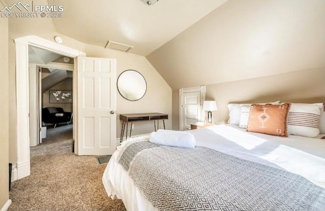 carpeted bedroom with vaulted ceiling