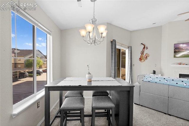 carpeted dining area featuring a chandelier