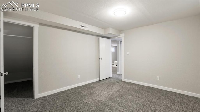 unfurnished bedroom featuring dark colored carpet