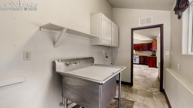 laundry room with washer hookup and cabinets