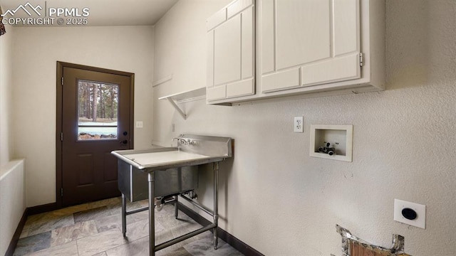 washroom with hookup for a washing machine, cabinets, and hookup for an electric dryer