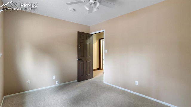 spare room featuring light colored carpet and ceiling fan