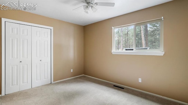 unfurnished bedroom with carpet flooring, a closet, and ceiling fan